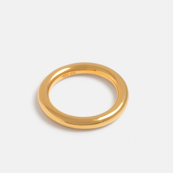Premium Photo | Two gold wedding rings on a round stand
